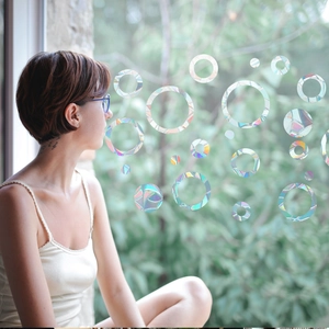 Rainbow prism window film showing static cling circle decals with laser light effects