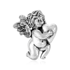 Vintage silver angel brooch with wings holding a heart on a white background