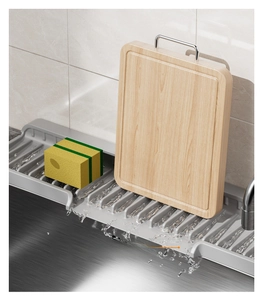 Detail of grey silicone sink drainer mat with sloped design for cutting boards and sponges