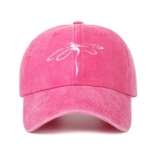Detail of rose red washed cotton baseball cap with white dragonfly print on the front