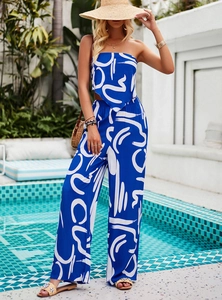 Blue and white bohemian floral print set with strapless top and wide-leg pants on model