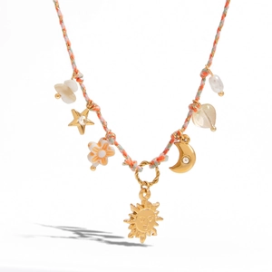 Detailed close-up of gold knotted sun and moon charms on a colorful woven rope necklace
