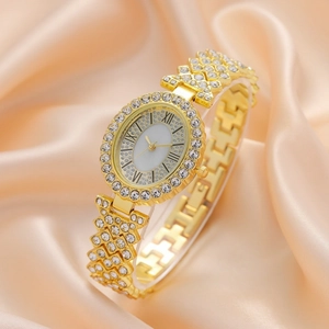 Elegant gold oval quartz watch with rhinestones on silk fabric background