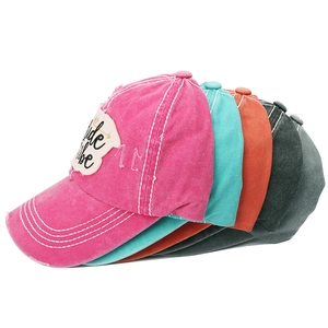 Detail view of colorful Bride Tribe embroidered washed baseball caps in 45-degree stack