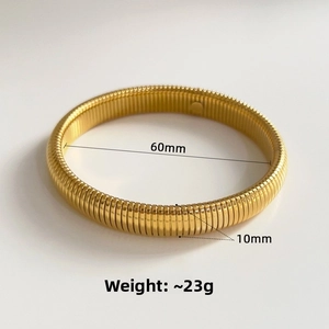 Macro shot of gold spiral textured stretch bracelet showing 60mm diameter and 10mm width