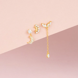 Detailed view of gold-plated moon earrings set with sparkling white zircon stones