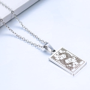 Detailed macro view of the silver stainless steel Pisces zodiac pendant on a chain