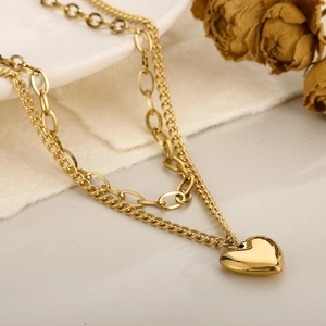 Double-layered gold titanium necklace featuring a paperclip chain and heart pendant