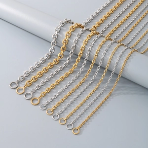 Detail of gold and silver stainless steel cable chains with OT toggles on a grey display