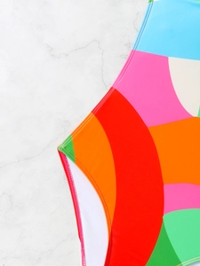 Detail of multi-color patchwork swimwear showing professional stitching and smooth texture