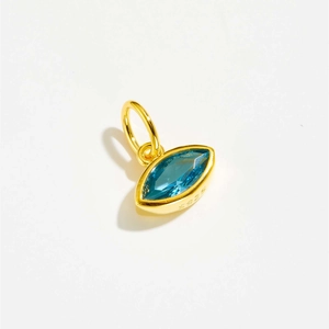 Macro view of gold S925 silver Evil Eye pendant with marquise-cut blue cubic zirconia