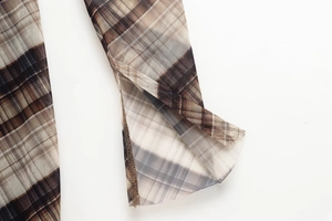 Detail shot of the retro plaid sheer mesh fabric with side slit and fine serged edge