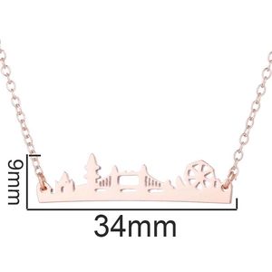 Rose gold skyline necklace featuring London Eye and Tower Bridge pendants on white background