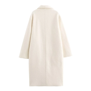 Rear view of long beige wool coat showing minimalist tailoring and back seam detail
