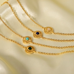 Bracelets vintage en acier doré avec pendentifs soleil et pierres de turquoise