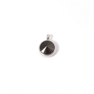 Detailed view of a round black crystal birthstone pendant with silver metal bezel