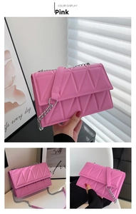 Detail view of pink quilted crossbody bag with silver chain strap and PU leather texture
