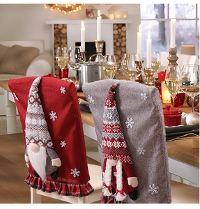 Detail of red and grey burlap Christmas chair covers with 3D gnomes and snowflake patterns
