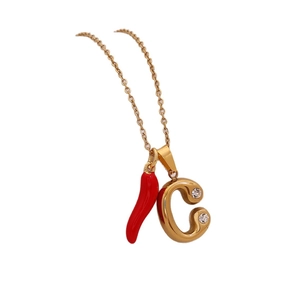 Gold letter C pendant and red chili charm necklace with thin chain on white background