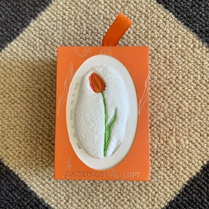 Orange gift box with tulip embroidered coral fleece towel and silk ribbon handle