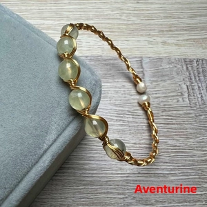 Detail of 14K gold wire wrapped bangle with prehnite beads and white pearls