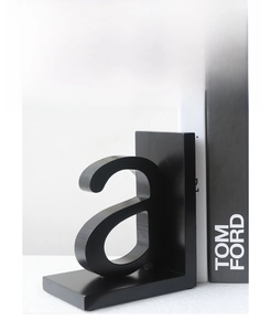 Detail view of black L-shaped letter A bookend made of matte MDF for shelf decor