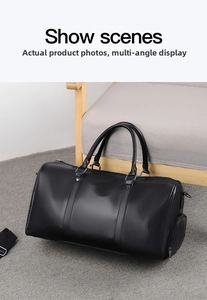 Detailed macro view of black pebbled leather travel bag with reinforced handles and hardware