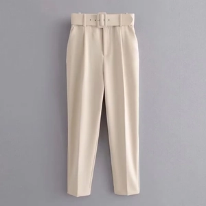 Detalle de pantalón beige de cintura alta con cinturón ancho a juego y corte entallado