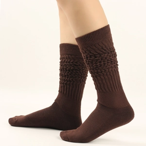 Detailed view of dark coffee slouch socks featuring thick cable knit texture and warm wool