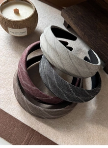 Detailed herringbone fabric texture on wide headbands in neutral autumn colors