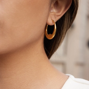 Classic 18K gold-plated moon-shaped stainless steel earrings on a female model