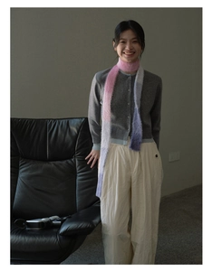 Close-up of fluffy pink and purple gradient scarf styled with a grey knitted cardigan