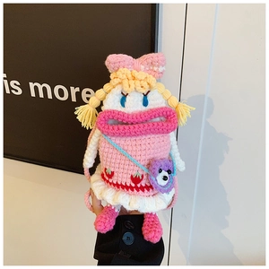 Close-up of handmade pink knit bag featuring a cute cartoon character with a big mouth