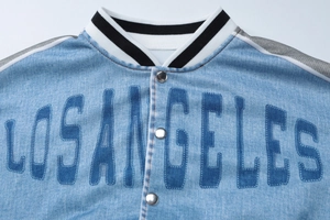 Detail of Los Angeles print on blue denim jacket with striped ribbed collar and metal buttons