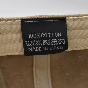 Macro shot of 100% cotton material tag and inner stitching of the washed baseball cap