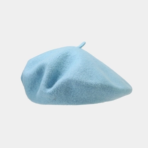 Detailed texture of light blue wool beret fabric with soft lighting and minimalist design