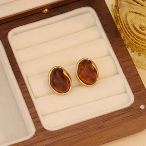 Vintage amber resin stud earrings with gold stainless steel edges in a luxury wooden box