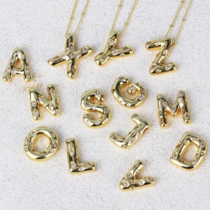 Detailed collection of gold hip hop initial pendants with sparkling cubic zirconia inlay