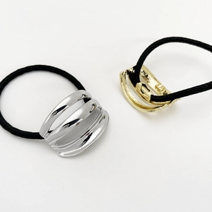 Minimalist elastic ponytail holders with gold and silver polished metal curved accents