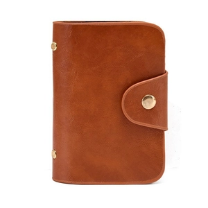 Detail of caramel brown PU leather card holder with three gold metal snap buttons