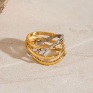 Detailed macro of a dual-tone intertwined gold and silver snake ring with shell inlay
