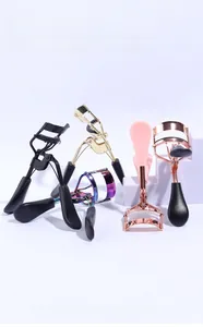 Close-up of colorful stainless steel eyelash curlers on blue minimalist background