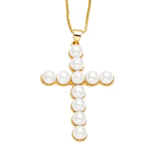 Elegant gold chain necklace featuring a minimalist cross pendant made of white pearls