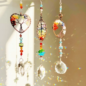 Close-up of tree of life suncatchers with colorful stones and crystal prisms for garden
