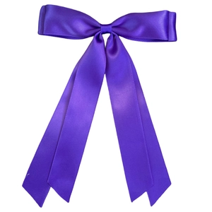 Close-up of a glossy purple satin ribbon bow hair clip with long flowing streamers