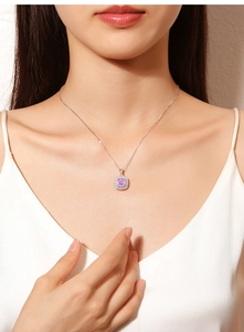 Close-up of S925 sterling silver necklace with square pink gemstone pendant on neck