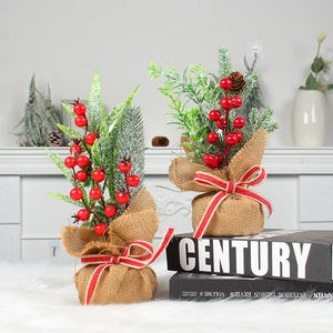 Mini Christmas tree with pine needles, red berries, cones and burlap base decoration