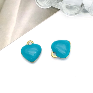 Detail of teal heart charm with gold trim for DIY jewelry making