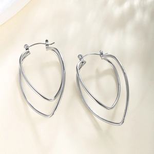 Close-up of silver geometric double-hoop earrings featuring nested chain texture design