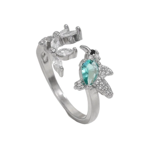 Macro detail of silver hummingbird ring featuring blue pear-shaped stone and zircon flower